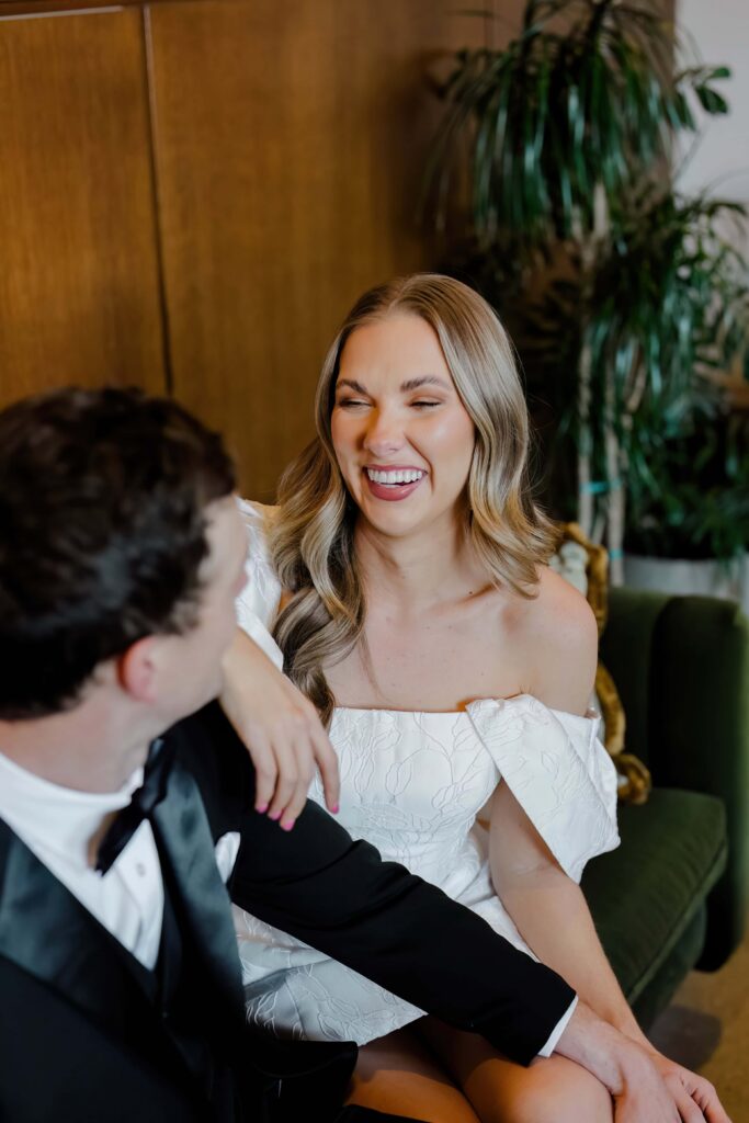  Bride laughing joyfully at her groom inside Hotel Emeline Charleston SC — intimate couples session photography by Felisha Lees Photography